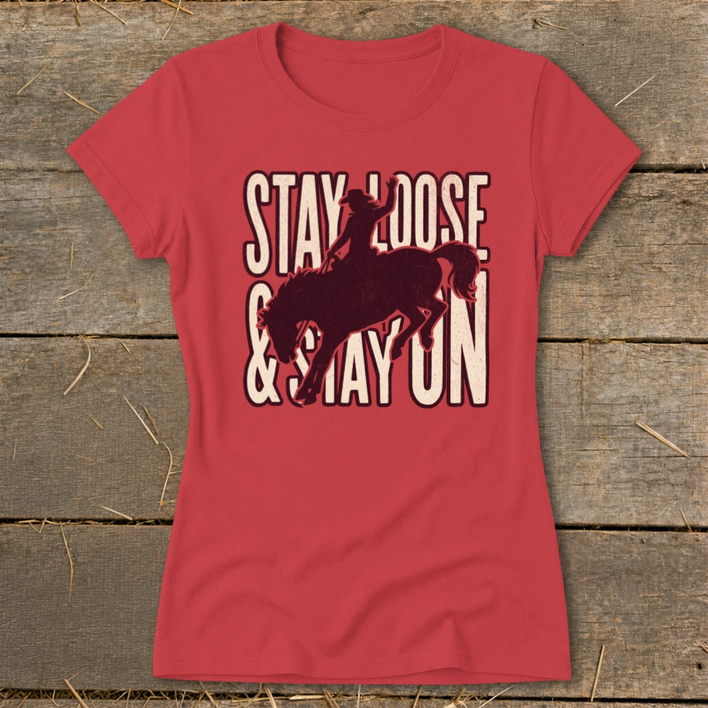 Red t-shirt with Stay Loose & Stay On graphic featuring a bucking bronco and rider.