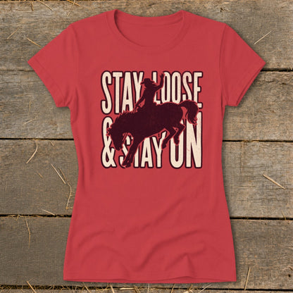 Red t-shirt with Stay Loose & Stay On graphic featuring a bucking bronco and rider.