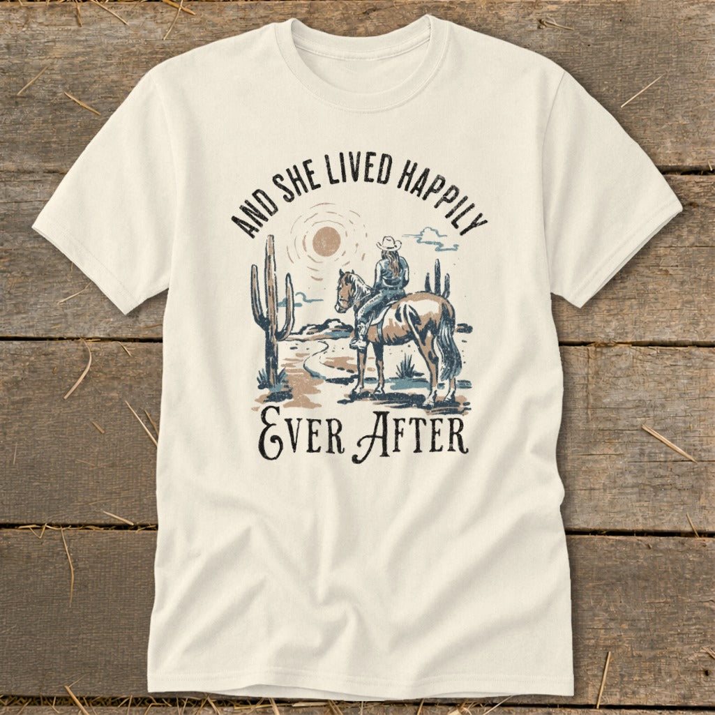 T-shirt with cowboy graphic and text "And She Lived Happily Ever After".