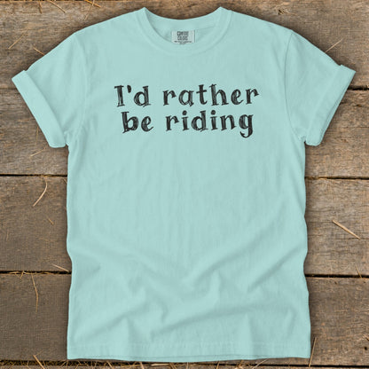Light blue t-shirt with black text reading "I'd rather be riding".