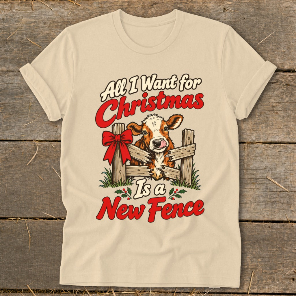 Cow with red bow behind wooden fence reads "All I Want for Christmas Is a New Fence".