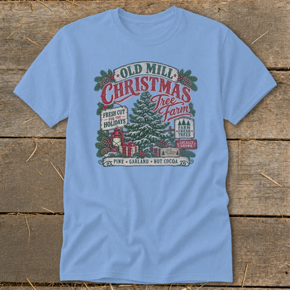 Light blue t-shirt with Old Mill Christmas Tree Farm graphic featuring a tree, gifts, and text.