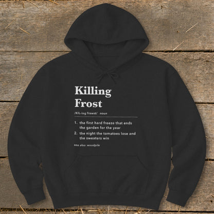 Black hooded sweatshirt featuring white dictionary-style text defining Killing Frost on a rustic wooden background.