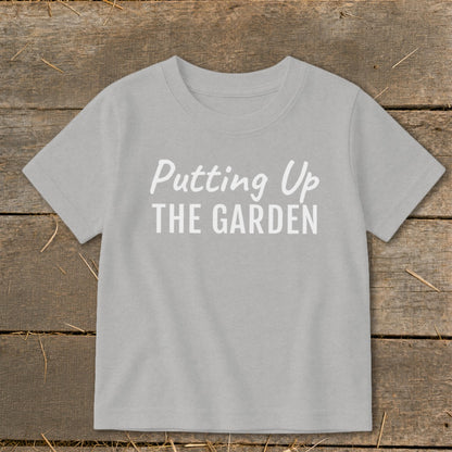 Light gray t-shirt with white text "Putting Up THE GARDEN"