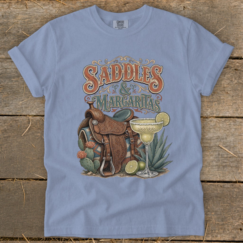 Light blue t-shirt with "Saddles & Margaritas" graphic featuring a saddle and margarita.