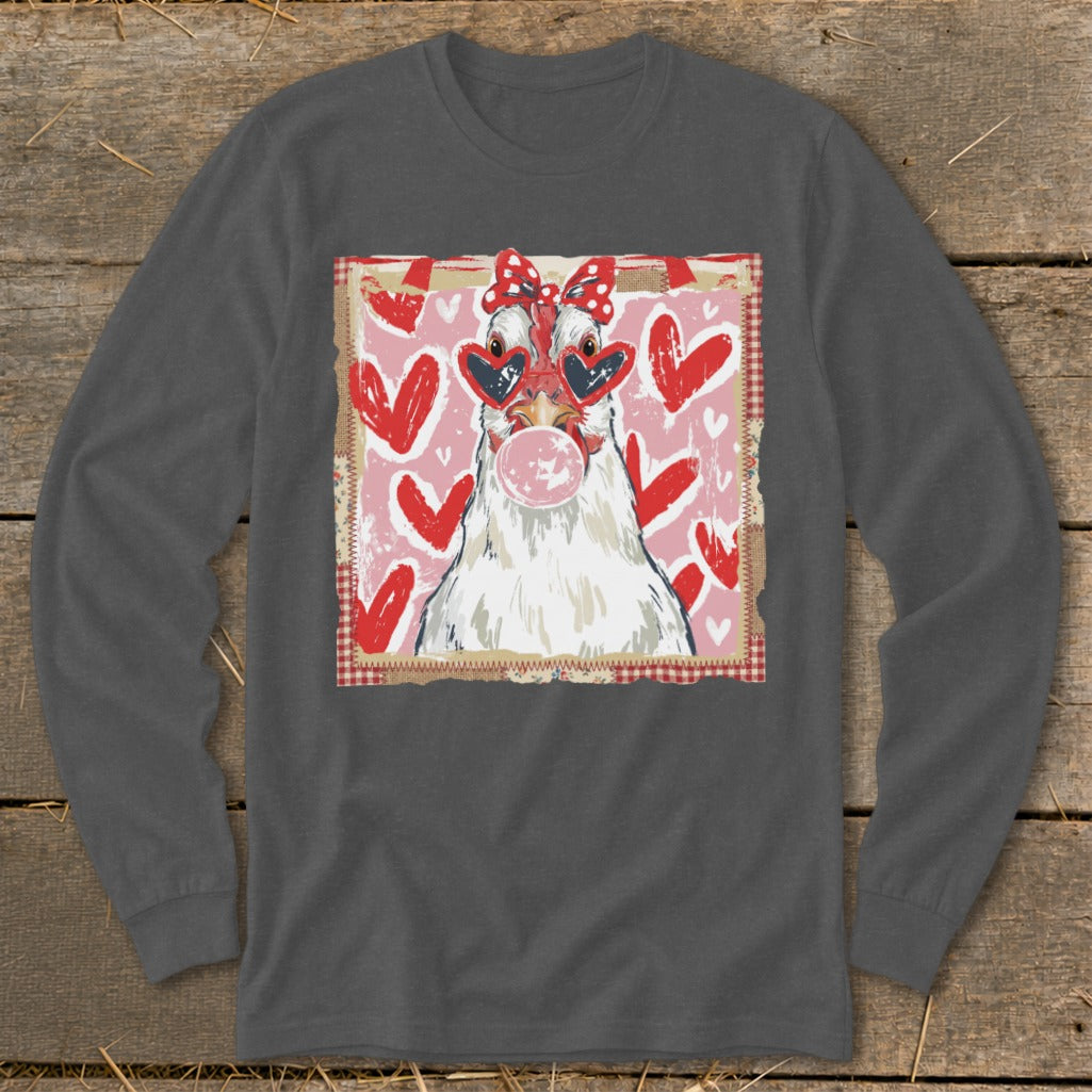 Chicken with heart sunglasses and bow blows bubblegum against pink heart background.