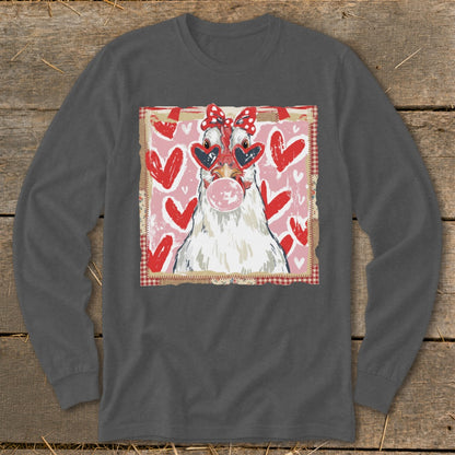 Chicken with heart sunglasses and bow blows bubblegum against pink heart background.