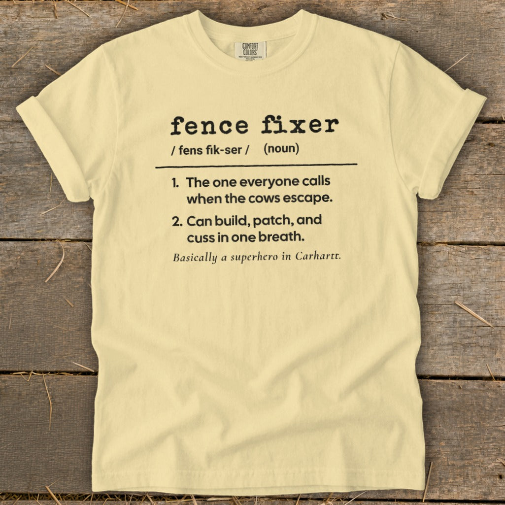 Light yellow t-shirt with "fence fixer" definition: "The one everyone calls when cows escape."