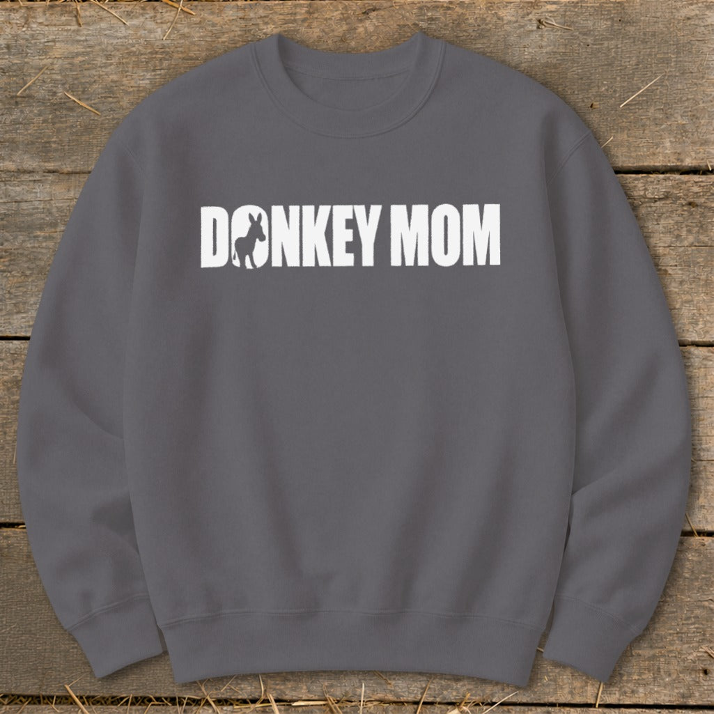 Dark grey crewneck sweatshirt featuring white text that reads DONKEY MOM with a donkey silhouette.