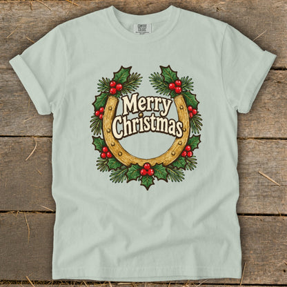 Light blue t-shirt with a horseshoe wreath graphic that reads "Merry Christmas".