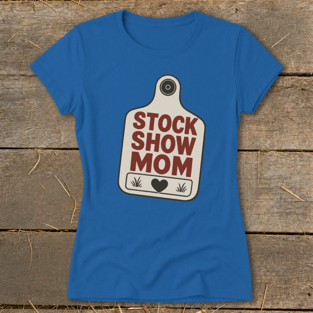 Blue t-shirt with "Stock Show Mom" text on a tag graphic.