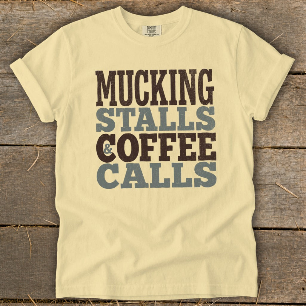 Pale yellow t-shirt with "Mucking Stalls & Coffee Calls" printed vertically.