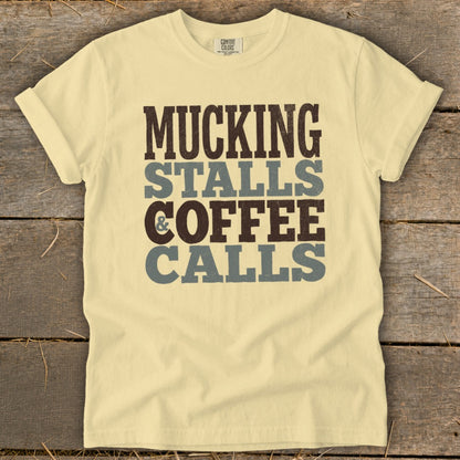 Pale yellow t-shirt with "Mucking Stalls & Coffee Calls" printed vertically.