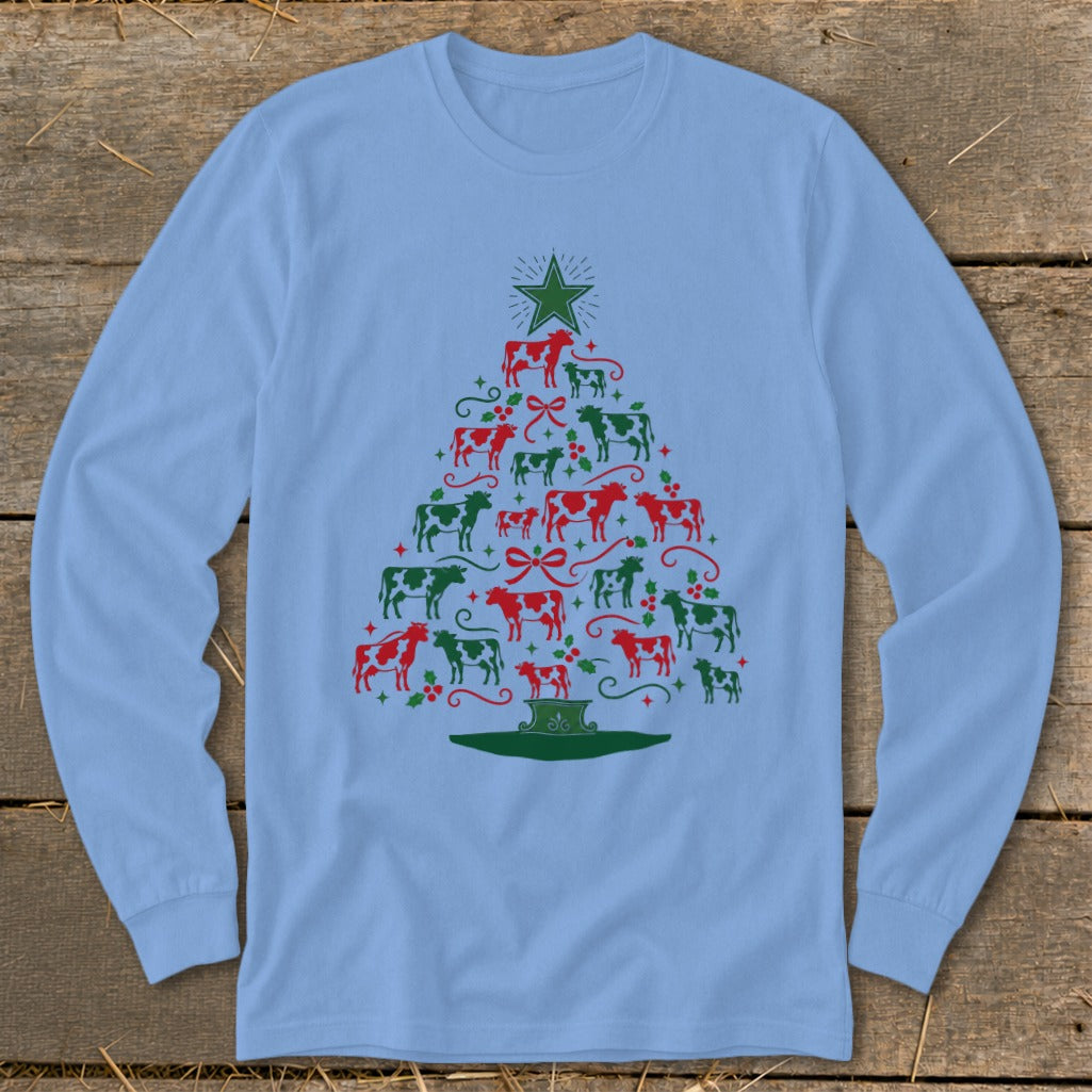 Light blue long-sleeve shirt with a Christmas tree made of red and green cows and festive accents.