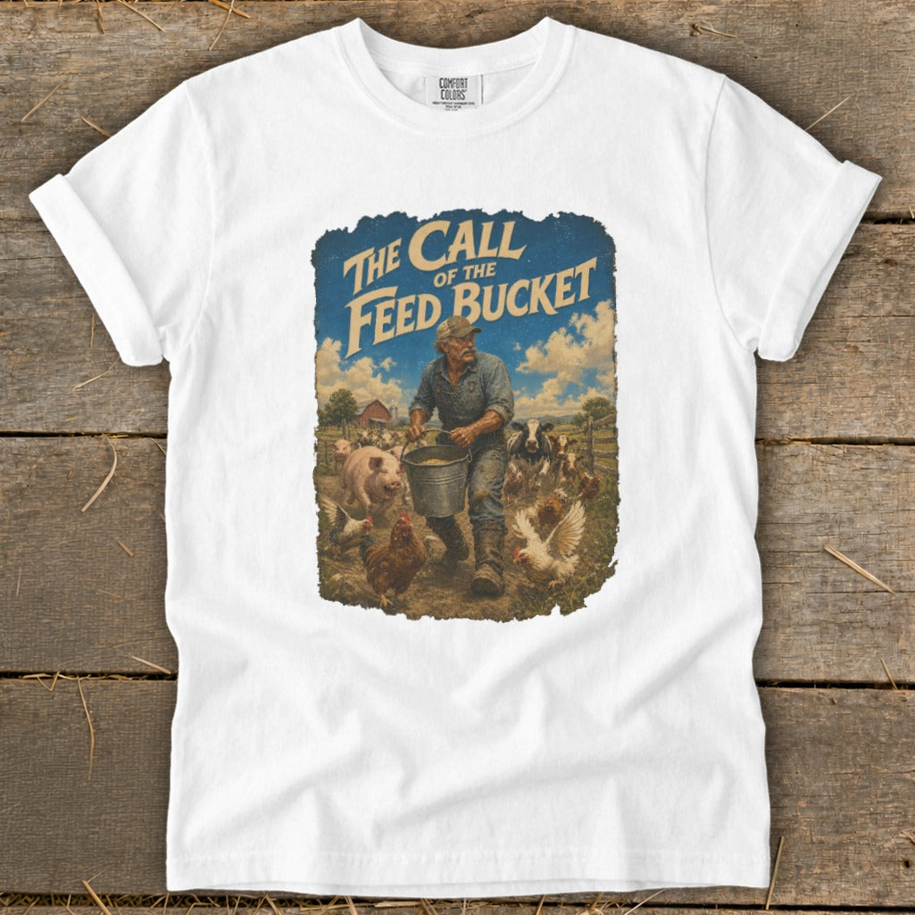 White t-shirt featuring "The Call of the Feed Bucket" graphic with a farmer feeding farm animals.