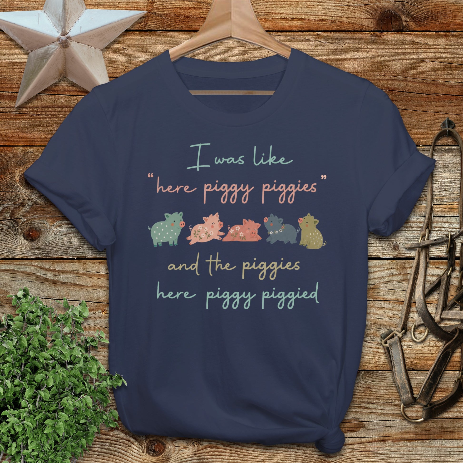 Navy t-shirt with piggies saying "here piggy piggies and the piggies here piggy piggied".