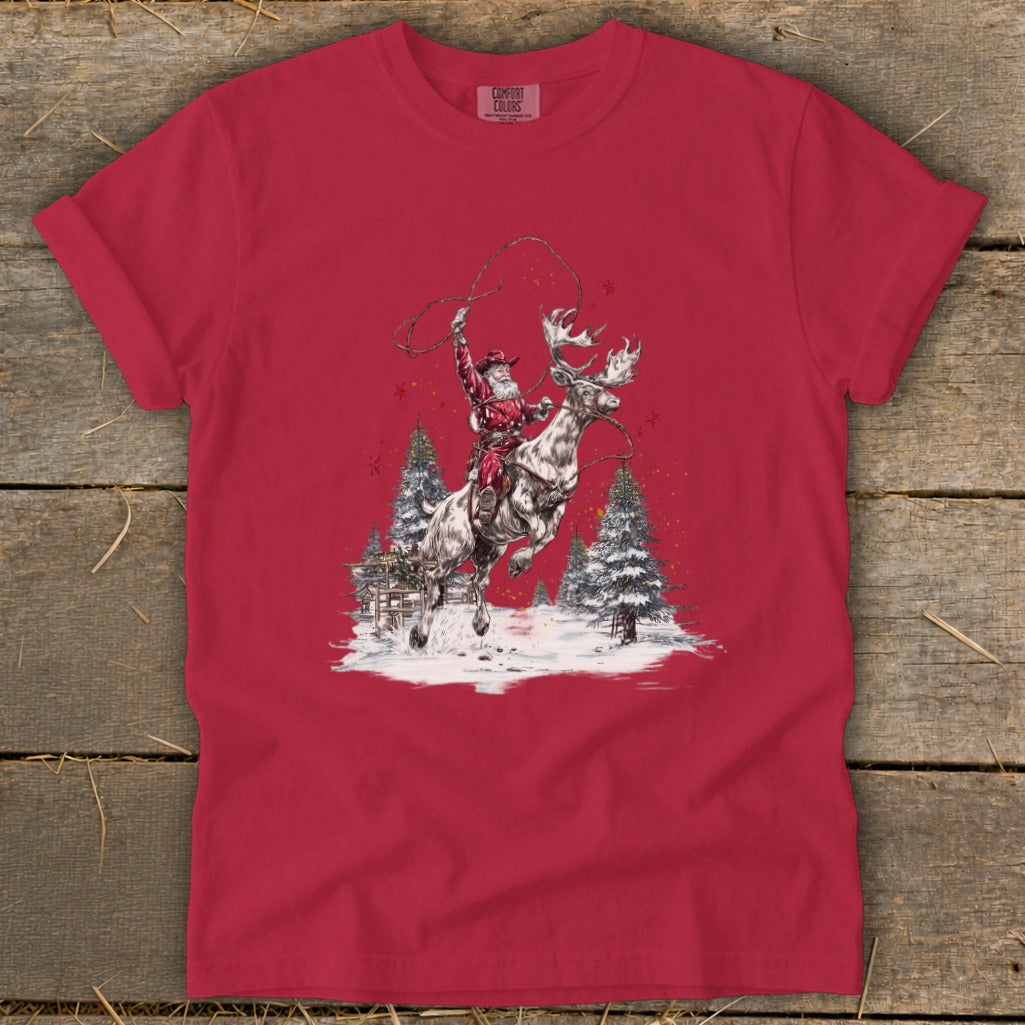 Santa on a reindeer with a lasso, in a snowy scene with pine trees.