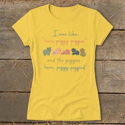 Yellow t-shirt with text "I was like 'here piggy piggies' and the piggies here piggy piggied" and cartoon pigs.