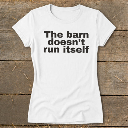 White t-shirt with black text reading "The barn doesn't run itself".