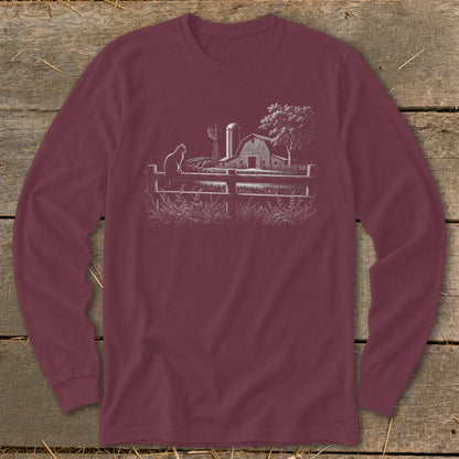 Maroon long sleeve shirt with a white line drawing of a farm scene with a cat.