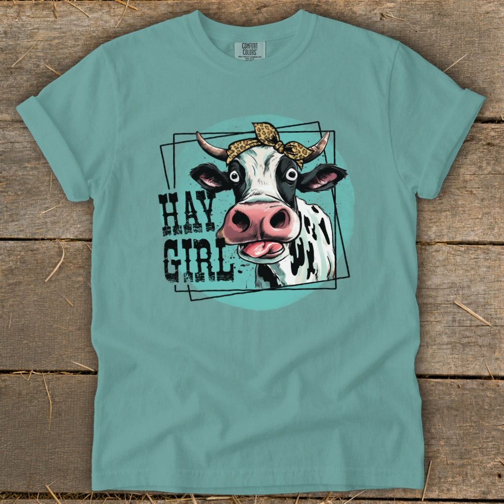 Cow with bandana and "Hay Girl" text on teal t-shirt