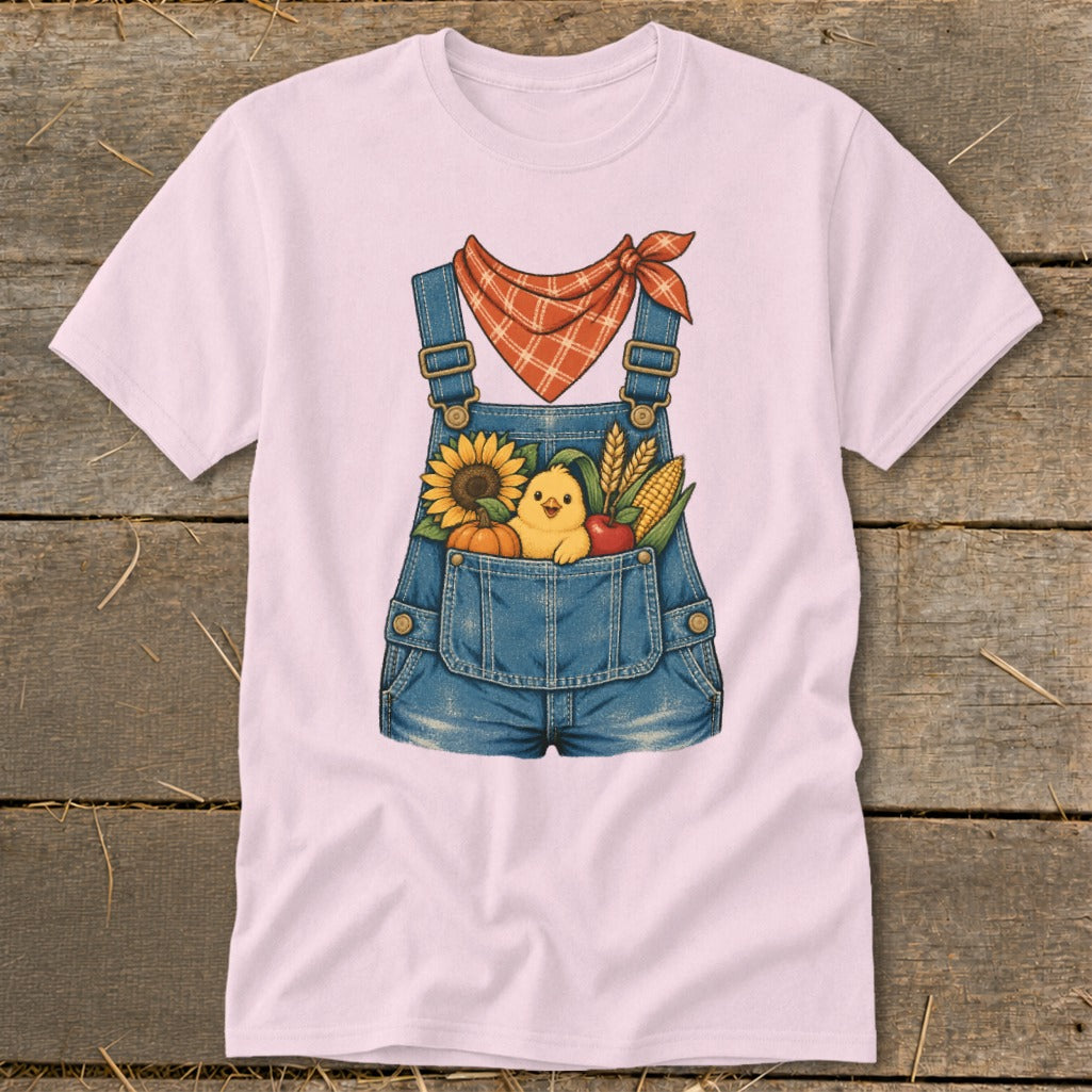 Pink t-shirt with a denim overalls graphic featuring a chick and fall harvest items.