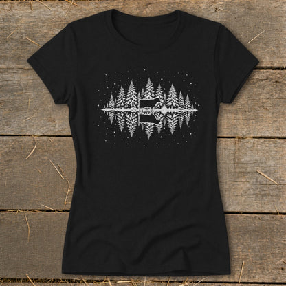 Black t-shirt with white graphic of a cow, pine trees, and stars reflected in water.