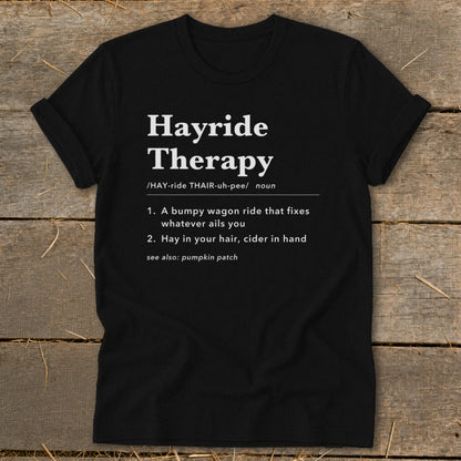 Black t-shirt with "Hayride Therapy" definition: bumpy wagon ride, hay in hair, cider in hand.