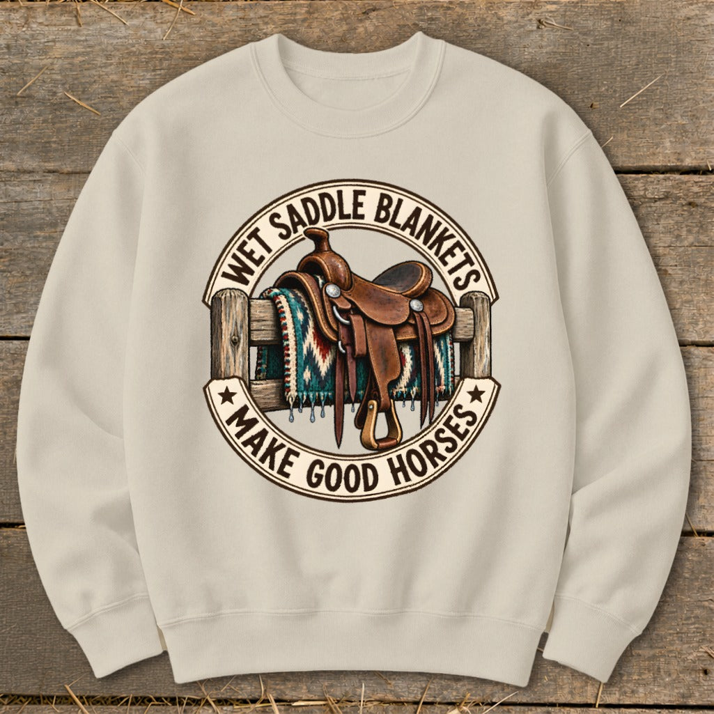 Crewneck sweatshirt with a circular graphic of a saddle on a fence with the text "Wet Saddle Blankets Make Good Horses".