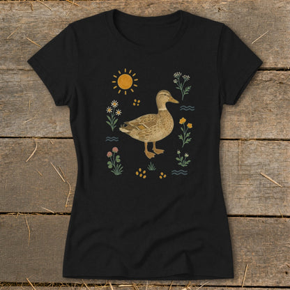 Black t-shirt with a watercolor duck surrounded by flowers and sun.