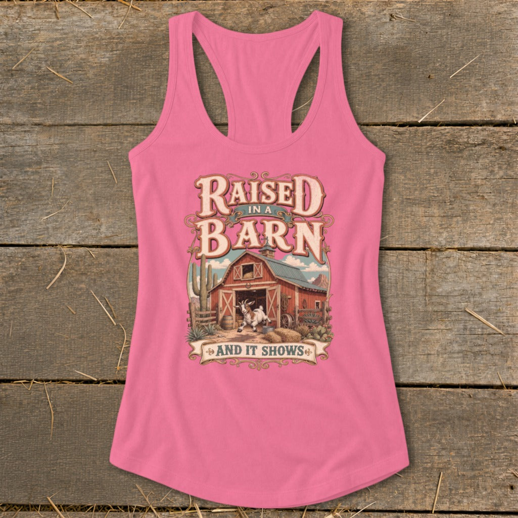 Pink tank top with "Raised in a Barn and It Shows" graphic and goat.