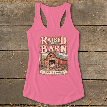 Pink tank top with "Raised in a Barn and It Shows" graphic and goat.