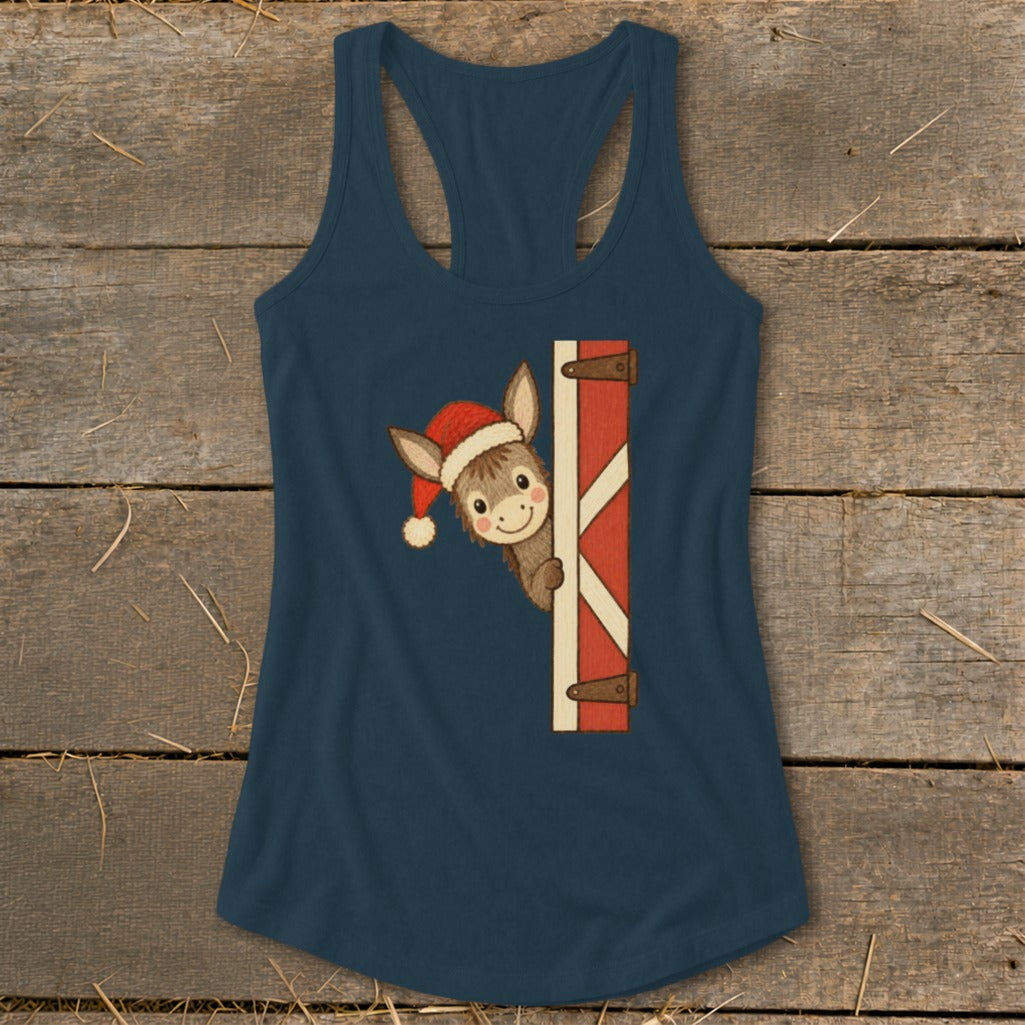 Donkey wearing Santa hat peeking from barn door on a navy tank top.