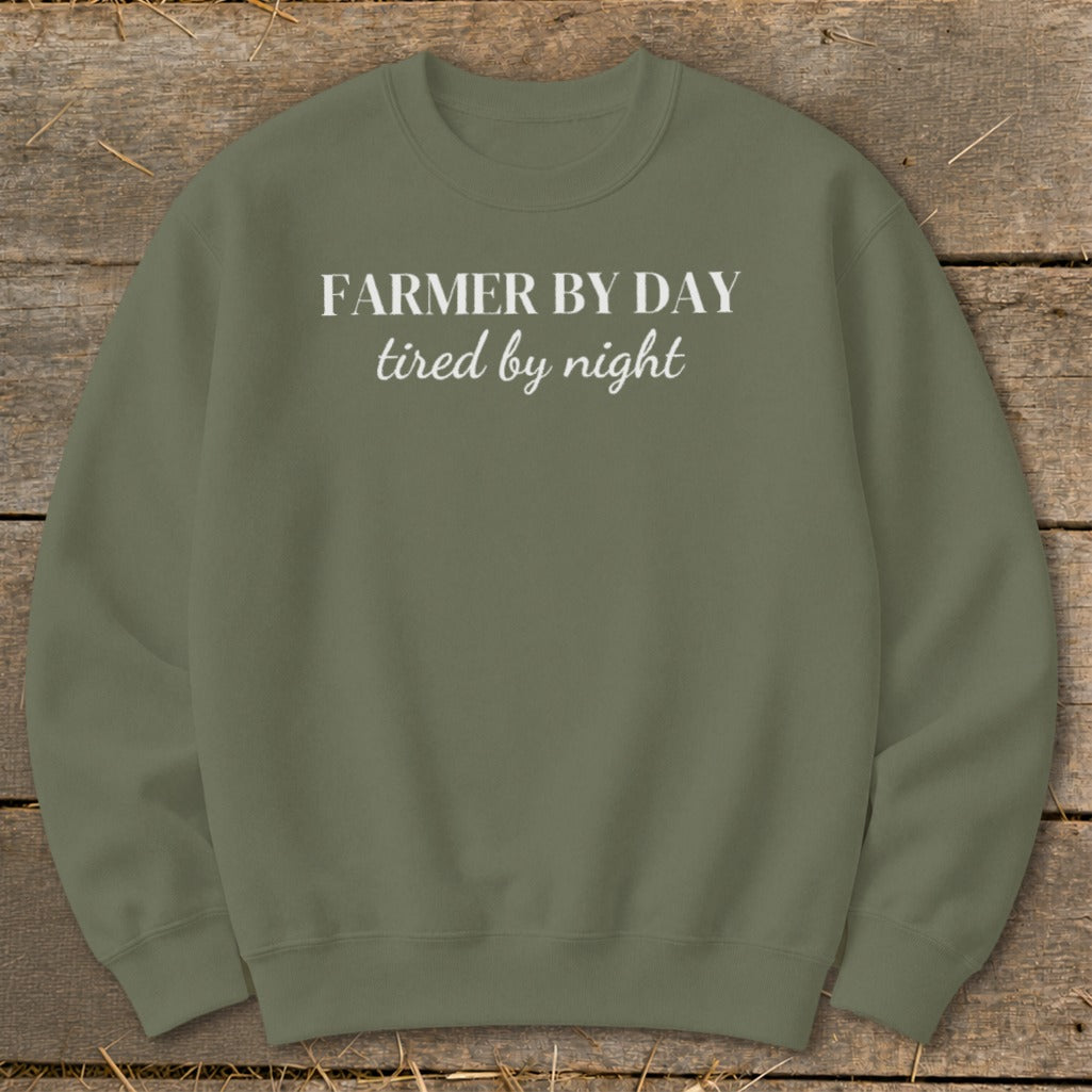Olive green sweatshirt with white text: Farmer by day, tired by night.