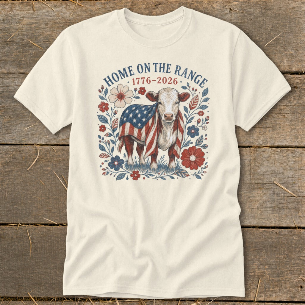 Cow wrapped in an American flag surrounded by flowers with text "Home on the Range 1776-2026".