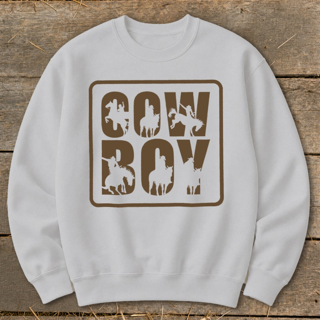 White sweatshirt with brown "COWBOY" text and cowboy silhouette designs.