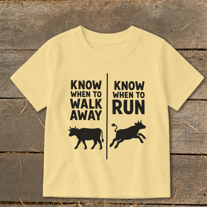 Yellow t-shirt with black text and cow graphics: "Know When To Walk Away" and "Know When To Run."