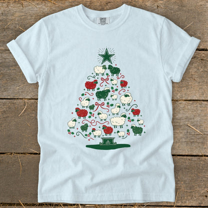 Light blue t-shirt with a Christmas tree made of red, green, and white sheep.
