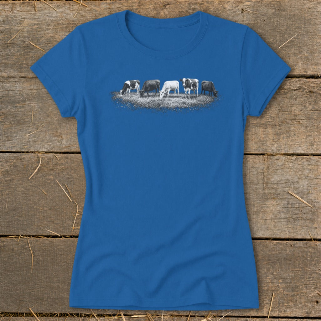 Blue t-shirt with a graphic of five cows grazing in a field.