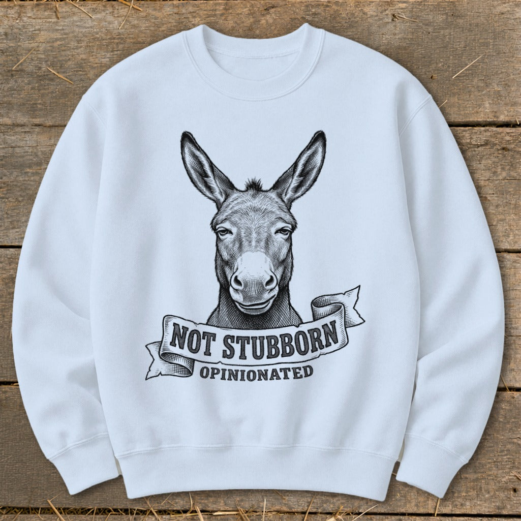 White sweatshirt with black graphic of a donkey's head on a banner reading "NOT STUBBORN OPINIONATED".