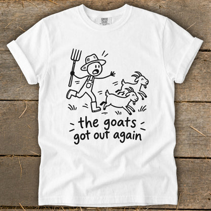 White t-shirt with cartoon of farmer chasing escaped goats and text "the goats got out again".