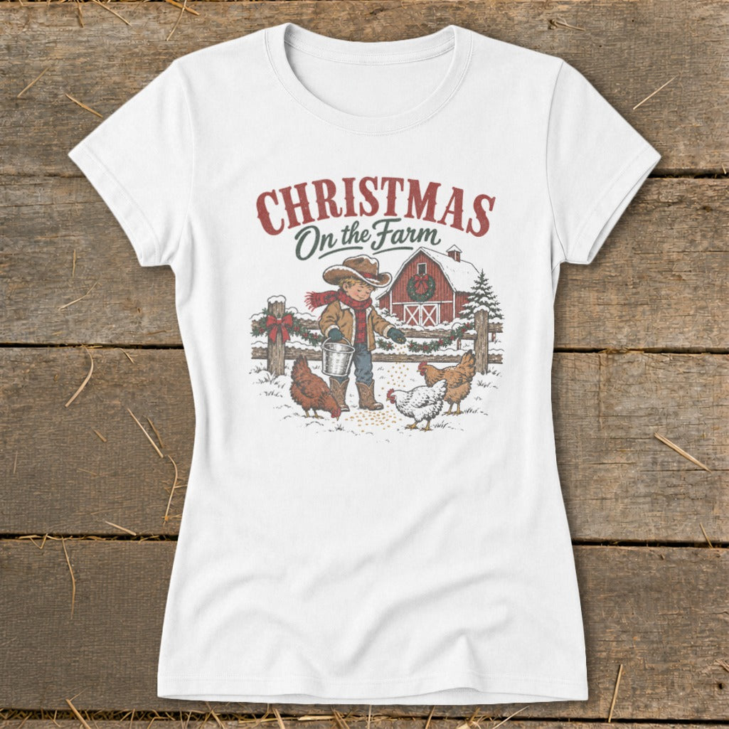 White t-shirt with "Christmas On the Farm" graphic of boy feeding chickens.