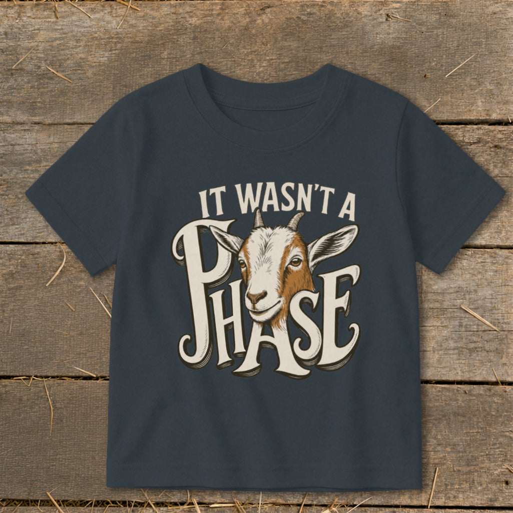 Dark grey t-shirt with text "IT WASN'T A PHASE" and a goat's head.