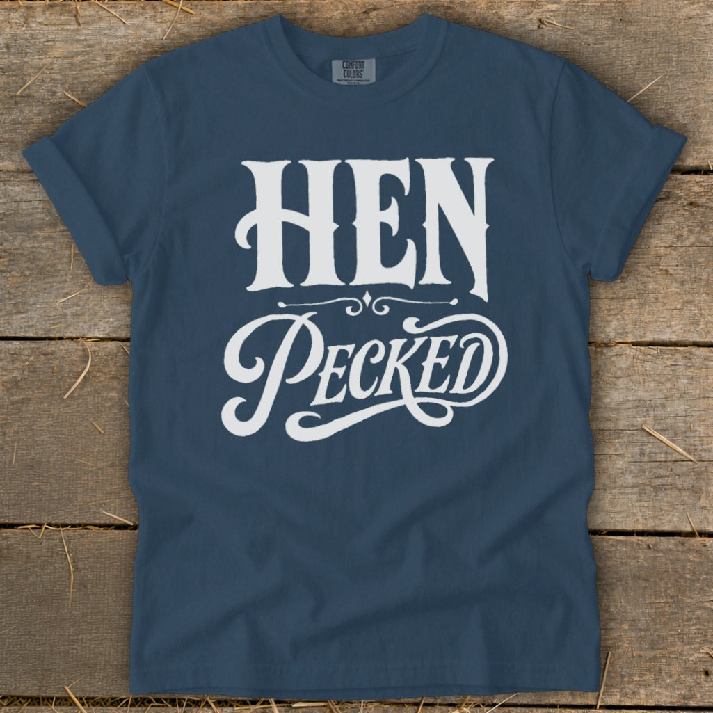 Navy t-shirt with white text reading "HEN Pecked" in decorative fonts.