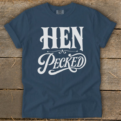 Navy t-shirt with white text reading "HEN Pecked" in decorative fonts.