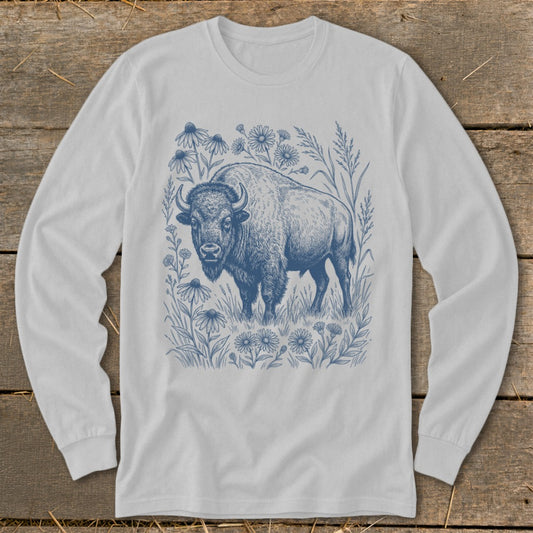 White long-sleeved t-shirt with blue illustration of a bison among wildflowers.