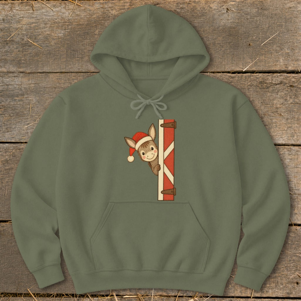 Olive green hoodie with cartoon donkey wearing a Santa hat peaking from behind a red and white striped gate.