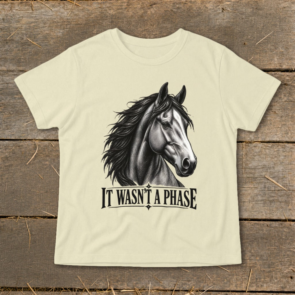Cream t-shirt with black drawing of a horse head and text "IT WASN'T A PHASE".