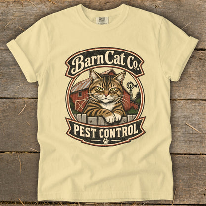 A light yellow t-shirt features a vintage circular logo with a tabby cat, a red barn, and the text "Barn Cat Co. Pest Control."