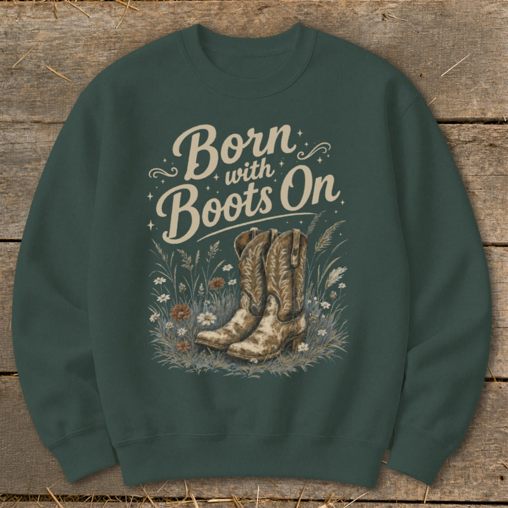 Crewneck sweatshirt with "Born with Boots On" text and cowboy boots in grass.